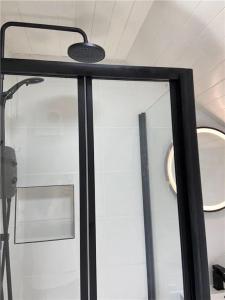 a glass door with a light on top of it at Thrush Cottage in Schull