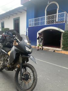 a man taking a picture of a motorcycle parked outside a building at Casa Volcán Granada in Granada