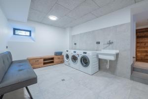 a bathroom with a washing machine and a sink at Plan de Corones Apartment in San Sigismondo