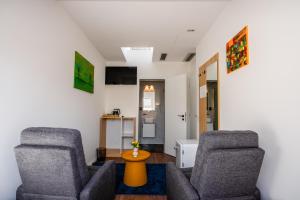 a living room with two chairs and a table at Zoe Hotel in Prishtinë