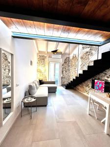 a living room with a couch and a staircase at Perla Loft in Seriate +27 photos