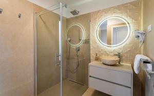 a bathroom with a shower and a sink and a mirror at Villa Carbonia in Kolan +37 photos