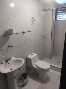 a bathroom with a toilet and a sink and a shower at HOTEL ASL HOME CALI NORTE - Hospedaje AV 6A NORTE in Cali