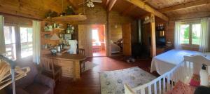 a bedroom and living room of a wooden cabin at Pikkjärve puhkemaja in Tilsi +33 photos
