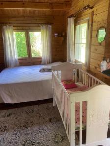 a bedroom with two beds and two windows at Pikkjärve puhkemaja in Tilsi