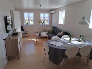 a kitchen and a living room with a table and chairs at Sønderborg Kær Vestermark in Sønderborg