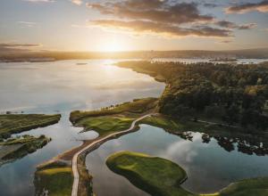 an aerial view of a golf course on a lake at Mayas Stuga in Sölvesborg