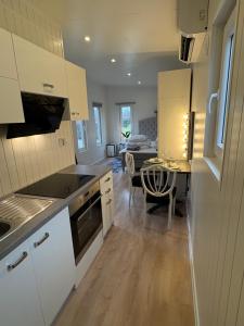 a kitchen with a table and a dining room at Mayas Stuga in Sölvesborg