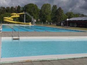 a large swimming pool with a water slide at Mayas Stuga in Sölvesborg