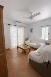 a living room with a couch and a coffee table at Cala Rajá 5 in La Isleta del Moro