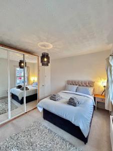 a bedroom with two beds and a large mirror at Charming 2 Bed Terrace in Central Caversham in Caversham +18 photos