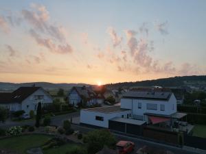 a view of a house with the sunset in the background at Lieblingsplatz in Ebersburg