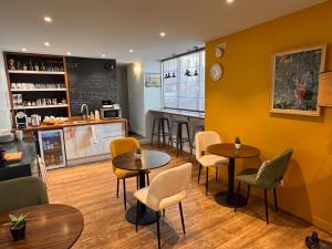 a restaurant with tables and chairs and a counter at 5 Chambres en Ville in Clermont-Ferrand