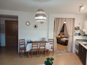 a kitchen and dining room with a table and chairs at El rincon de Adriana in Alquézar