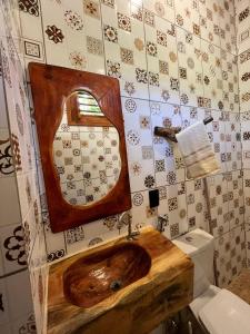 a bathroom with a wooden sink and a toilet at Point lanabarra in Amontada