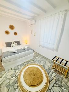 a bedroom with a bed and a rug on the floor at Danae’s cycladic house in Kampos Paros +30 photos