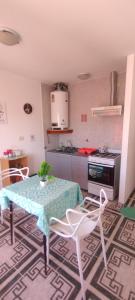 a kitchen with a table and chairs in a kitchen at Dulce Adelina III - Zona Céntrica in Río Grande