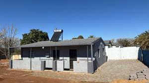 a black building with a solarium on top of it at Albam residency kuruman in Kuruman