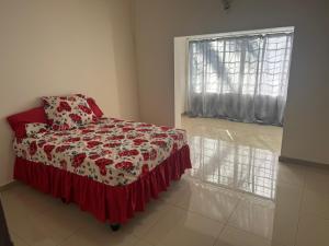 a bedroom with a bed with a red and white blanket at Albam residency kuruman in Kuruman