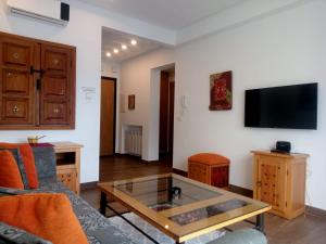 a living room with a couch and a glass coffee table at Esmeralda in Douar el Hafey