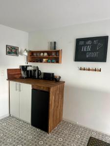 a kitchen with a wooden counter top and a counter top at Stadtwohnung Hygge Home in Neustadt in Holstein