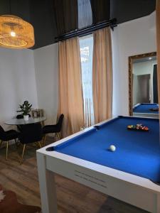 a pool table in a living room with a mirror at Le Joyau du lac in Charavines
