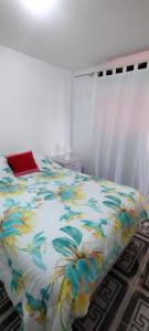 a bedroom with a bed with a colorful comforter at Dulce Adelina III - Zona Céntrica in Río Grande