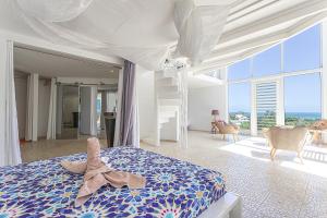 a bedroom with a bed with a large window at Villas ti creole nogent in Sainte-Rose +64 photos