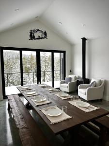 a large wooden table in a living room at Black Arrow Chalet in Courtenay