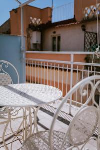 a white table and chairs on a balcony at Residenza Delle Sirene in Gaeta