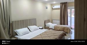 a hotel room with two beds and a window at Motel La Casbah in Constantine