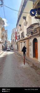a person with an umbrella standing next to a building at Motel La Casbah in Constantine