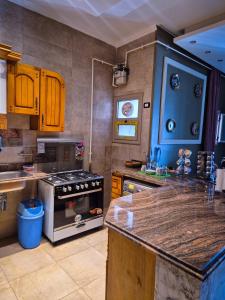 a kitchen with a stove and a counter top at Galleria 1 in New cairo