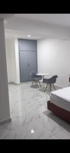 a room with two chairs and a bed in it at RUKA Hotel in Punta Cana