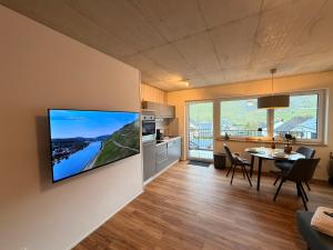 a living room with a flat screen tv on a wall at Sonnenufer Apartment & Wein III in Bernkastel-Kues