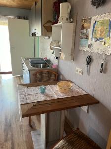 a small kitchen with a table and a sink at Apartment Rotdornblüte in Wustrow +5 photos