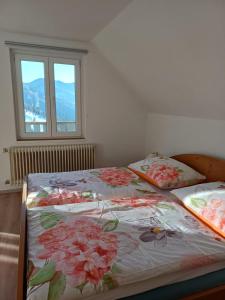 two beds in a room with flowers on them at Ferienhaus Häusler in Sankt Erhard