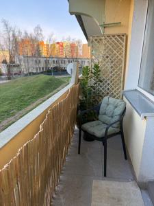 a chair sitting on a porch next to a fence at Apartament Grodzka in Wałbrzych