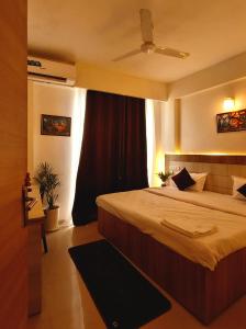 a bedroom with a large bed and a window at Peaceful Stay at Vrindavan in Vrindāvan