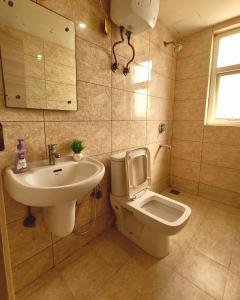 a bathroom with a sink and a toilet at Peaceful Stay at Vrindavan in Vrindāvan