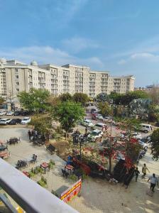 a large apartment building with a park in front of it at Peaceful Stay at Vrindavan in Vrindāvan