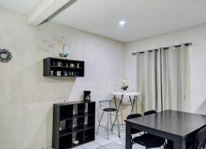 a dining room with a black table and chairs at Casa Jaguar 7 in Puerto Morelos