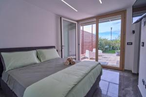 a bedroom with a large bed with shoes on it at SunStyle House Villetta Rimini con Giardino e Park in Casalecchio +67 photos