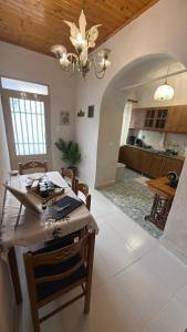 a dining room and kitchen with a table and a chandelier at Elia in Kalamoti