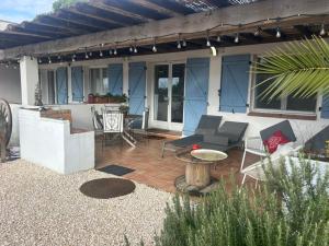 a patio with chairs and a table on a house at Gite Armieux in Saintes-Maries-de-la-Mer