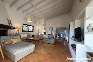 a living room with a couch and a table at Casa Lilu Playa Migjorn - Formentera Natural in Playa Migjorn +20 photos