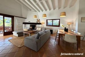 a living room with a couch and a table at Casa Lilu Playa Migjorn - Formentera Natural in Playa Migjorn