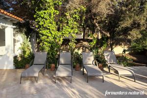 a group of chairs sitting on a patio at Casa Lilu Playa Migjorn - Formentera Natural in Playa Migjorn