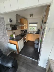 a small kitchen with a sink and a stove at Modern retreat in Caernarfon