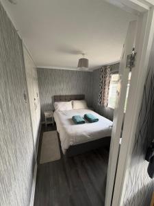 a small bedroom with a bed and a window at Modern retreat in Caernarfon